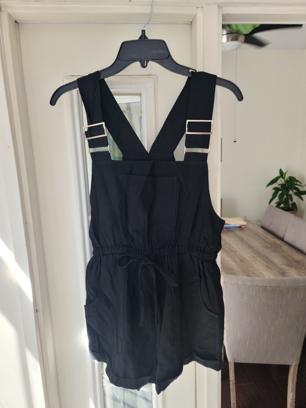 Kittenish Black Adjustable-Strap Romper with Front Pocket